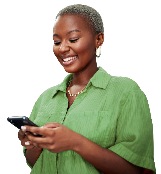 a woman smiling looking at her phone in her hands